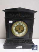 A Victorian black slate mantel clock with brass and enamelled dial