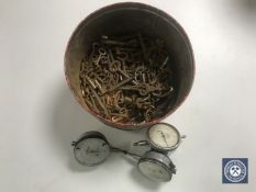 A tin of antique keys together with three meters