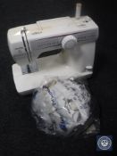 A Toyota electric sewing machine with foot pedal and cover