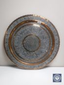 An Eastern charger, in silver and copper finish,