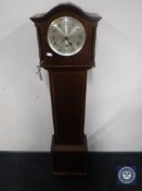 An inlaid granddaughter clock with pendulum and key