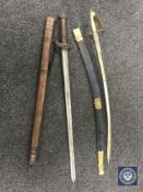 A brass handled Indian sword together with one other