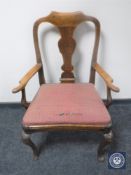 An antique oak framed armchair