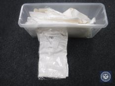 A quantity of vintage mens' white collarless shirts.