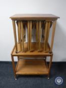 A teak table fitted four folding tables beneath and a teak tea trolley