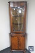 A mahogany inverted bowfront corner display cabinet