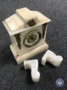 A Victorian alabaster mantel clock with metal mounts and a pair of similar bookends