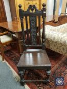 A Victorian carved oak hall chair,