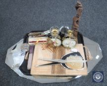 An early 20th century frameless bevelled mirror together with a tray containing cut throat razor,