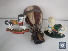 A wooden hot air balloon with basket together with two miniature cast iron horse door stops