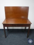 A Victorian mahogany foldover tea table