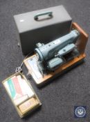A cased vintage Singer sewing machine with accessories