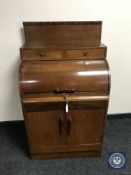 An oak Art Deco barrel fronted bureau