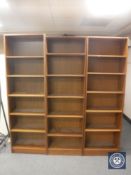 Three sets of narrow teak open shelves