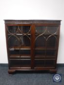 A late Victorian mahogany double door display cabinet on bracket feet
