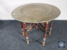 A folding Eastern brass topped table