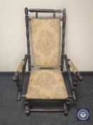 A mahogany framed tapestry upholstered American style rocking chair