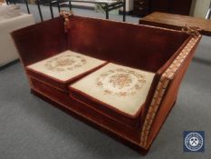 An early 20th century two seater drop end settee in red corded fabric