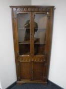 An oak corner display cabinet