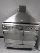 A Smeg stainless steel five burner gas range cooker together with an extraction hood,