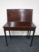 A 19th century mahogany turnover top tea table