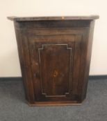 A Georgian oak hanging corner cupboard