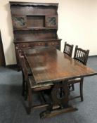 An oak refectory dining table together with a set of four oak tapestry seated dining chairs