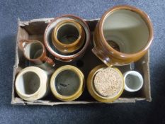 A box containing seven stoneware kitchen jars together with a stone ware jug