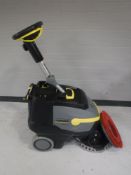 A Karcher Professional BT38/12C floor cleaner with brush attachment