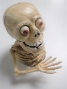 A cast iron novelty skeleton money box