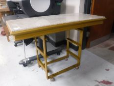 A gilt metal marble topped side table on castors