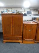 An inlaid yew wood double door television cabinet together with a similar audio cabinet