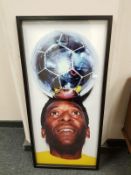 A colour photograph depicting Pele with a football balanced on his head,