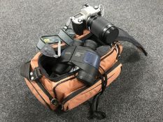 A camera bag containing Nikon F65 camera with strap and lenses, Sigma zoom lens, Hanimex flash,