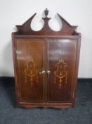 An inlaid mahogany double door wall cabinet