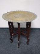 A folding Eastern brass topped table