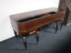 A 19th century inlaid mahogany table piano case on reeded legs