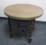 A circular brass topped table on barley twist legs