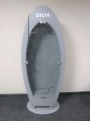 A shop display cabinet in the form of a surf board