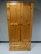A pine double door wardrobe fitted two drawers