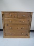 A contemporary pine five drawer chest