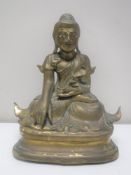 An antique lacquered brass figure of an Eastern deity