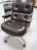 A 20th century chrome framed brown buttoned leather swivel office armchair
