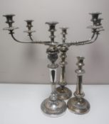 A pair of Sheffield plated candelabrum and single candlestick (3)