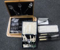 A tray containing oak canteen of stainless steel cutlery, cased servers,