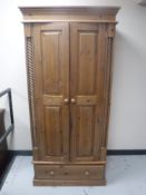A contemporary pine double door wardrobe fitted a drawer