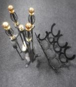 A four-piece companion set on stand with a cast metal horseshoe magazine rack