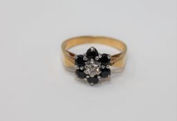 An 18ct gold sapphire and diamond cluster ring