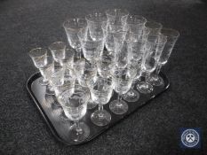 A tray of four sets of six etched glasses - champagne flutes, wine glasses,