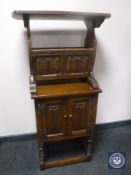 A Priory Oak linen fold double door cabinet and matching mag rack